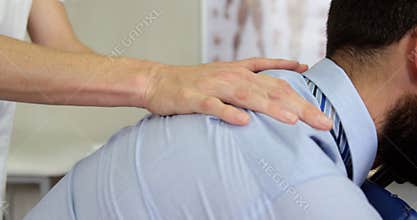 Physiotherapist giving back massage to a patient