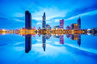 Cityscape in reflection of Ho Chi Minh city at beautiful twilight, viewed over Saigon river.