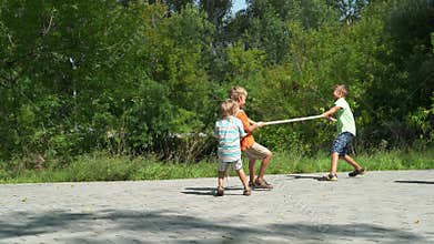 Kids pull the rope in sunny day