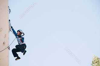 Ice climber on wall