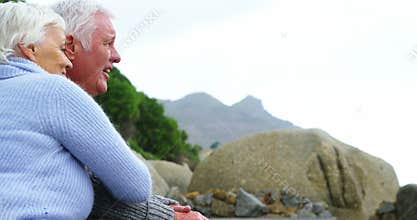 Senior couple embracing each other on the beach