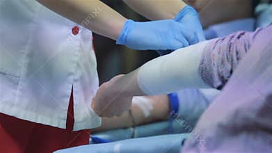 Doctor bandaging a patient`s arm with a bandage