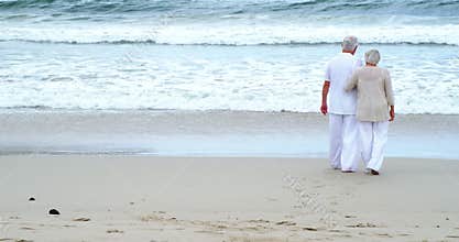Senior couple walking on the beach