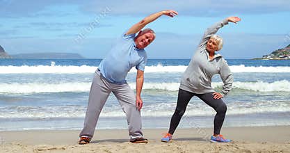 Senior couple performing stretching exercise