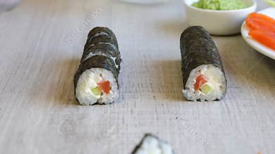 Making sushi woman roll a seafood