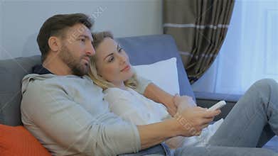 Couple watches TV at home
