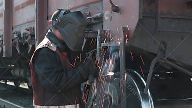 Man welding railway carriage