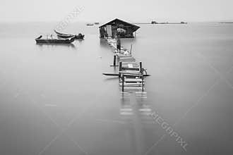 Water overflow on a broken wooden bridge in black and white