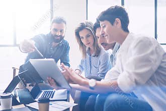Business meeting concept.Coworkers team working new startup project at modern office.Analyze business documents, using