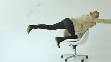 Slowmotion of Bearded funny businessman have fun riding on office chair on white background