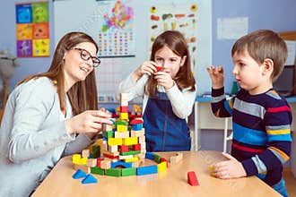 Teacher and kids Together with colorful building toy blocks