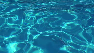 Water in the pool, sunlight is reflected, small waves, slow-motion shooting.