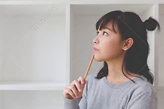 asian girl female teenager student thinking something beside boo