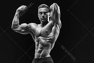 Bodybuilder with muscular physique looking at camera showing bic