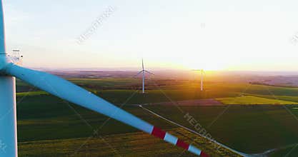 Aerial view of summer countryside with wind turbines and agricultural fields 4K