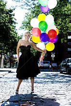 Blond with balloons out in the sun