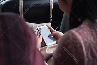 Close up girl using smart phone from behind