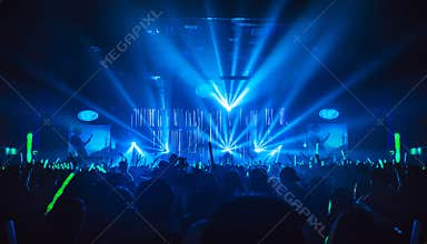Silhouette in night club under blue light rays beam