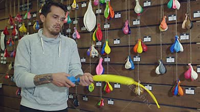 A man blows up a balloon pump