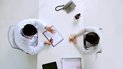 Doctor giving diet plan to patient at hospital