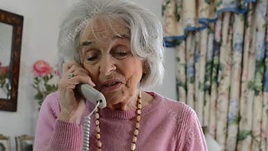 Smiling Senior Woman Talking On The Telephone At Home