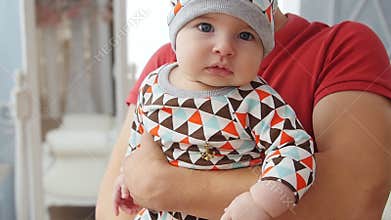 Father holds the baby boy in his arms