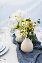 Beautiful table setting with white and green flowers