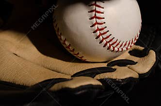 Baseball with Glove on Black Background