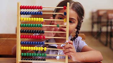 Cute pupil learning maths with an abacus