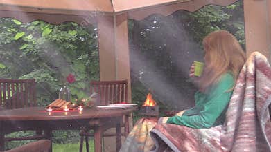 Lonely girl sit near table with burn candles and drink alcohol