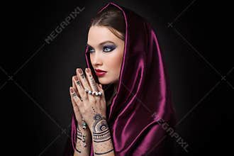 Beautiful woman in oriental style with mehendi