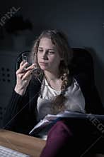 Woman working and drinking alcohol