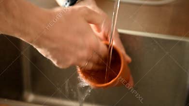Man washes a cup