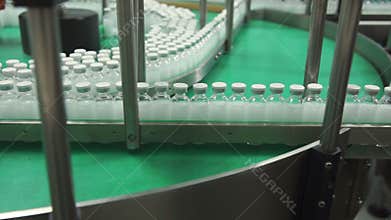 Bottles with drugs on the conveyor line in pharmaceutical factory
