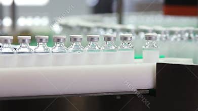 Bottles with drugs on the conveyor line in pharmaceutical factory