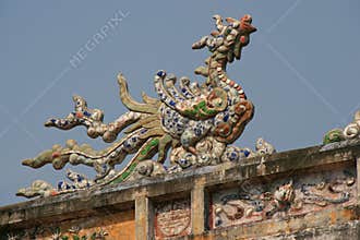A sculptured phoenix decorates the ridgepole of a palace in Hue (Vietnam)