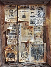 A Wooden Frame Full of Wanted Posters