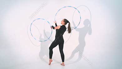 Spinning acrobat beautiful hula hoops in slow motion