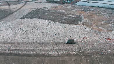 Aerial Shot Landfill with Working Trucks and Tractor