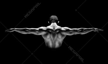 Rear view of healthy muscular man with his arms stretched out isolated on black background