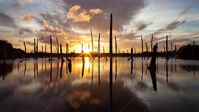 Apocalyptic dramatic clouds and sunset over lake, time-lapse
