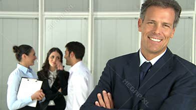 Happy smiling business man with colleagues
