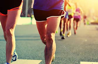 People feet on city road in marathon running race