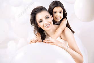Closeup portrait of young mom with a cute daughter