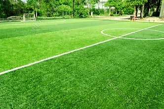 White stripe on artificial green grass of soccer field