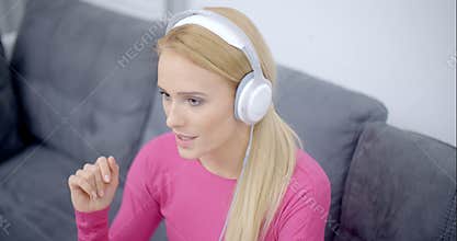 Woman Listening Music From Phone Using Headset