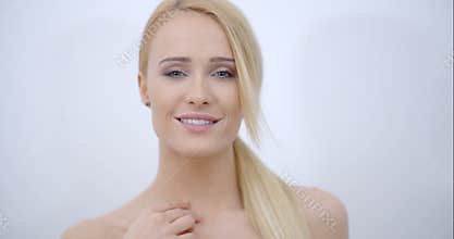 Smiling Bare Woman Touching her Face