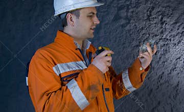 Engineer inspecting mineral