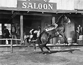 Cowboy being thrown off his horse