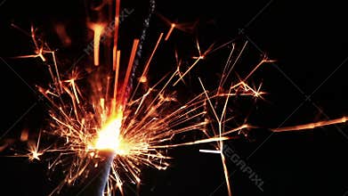Close-up of firework sparkler burning on black background, congratulation greeting party happy new year, christmas celebration
